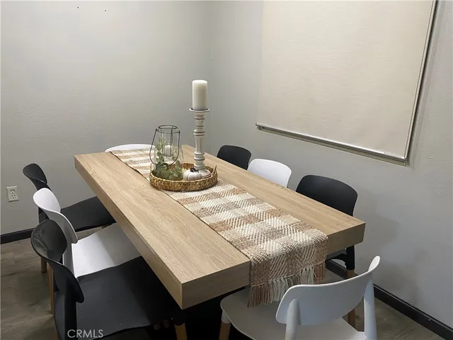 a dining room with furniture and wooden floor