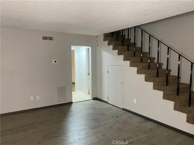 a view of entryway with stairs and wooden floor