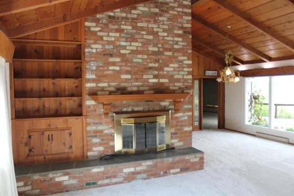 a view of an empty room with a fireplace