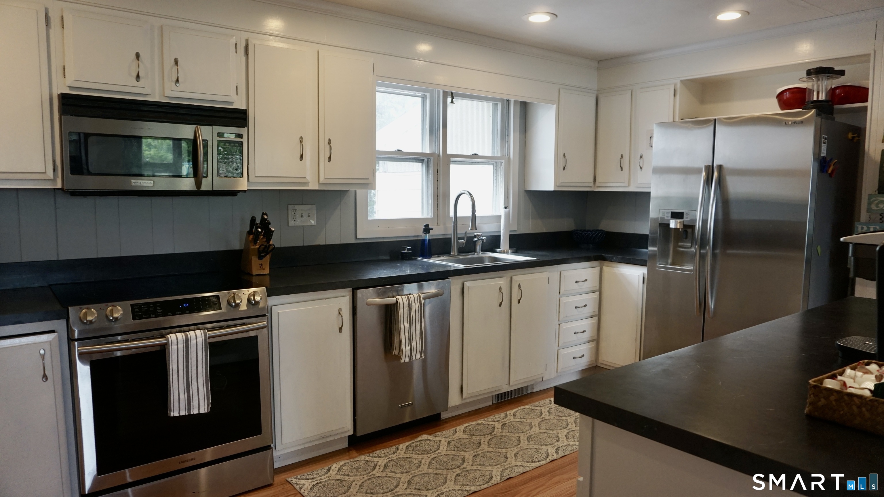13 Pacific Street Groton, CT 06340 - Photo 5 of 31 a kitchen with stainless steel appliances granite countertop a stove a refrigerator and a microwave