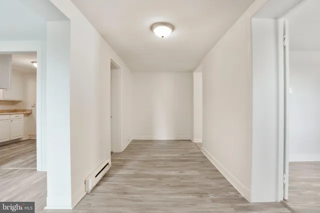 a view of a hallway with wooden floor