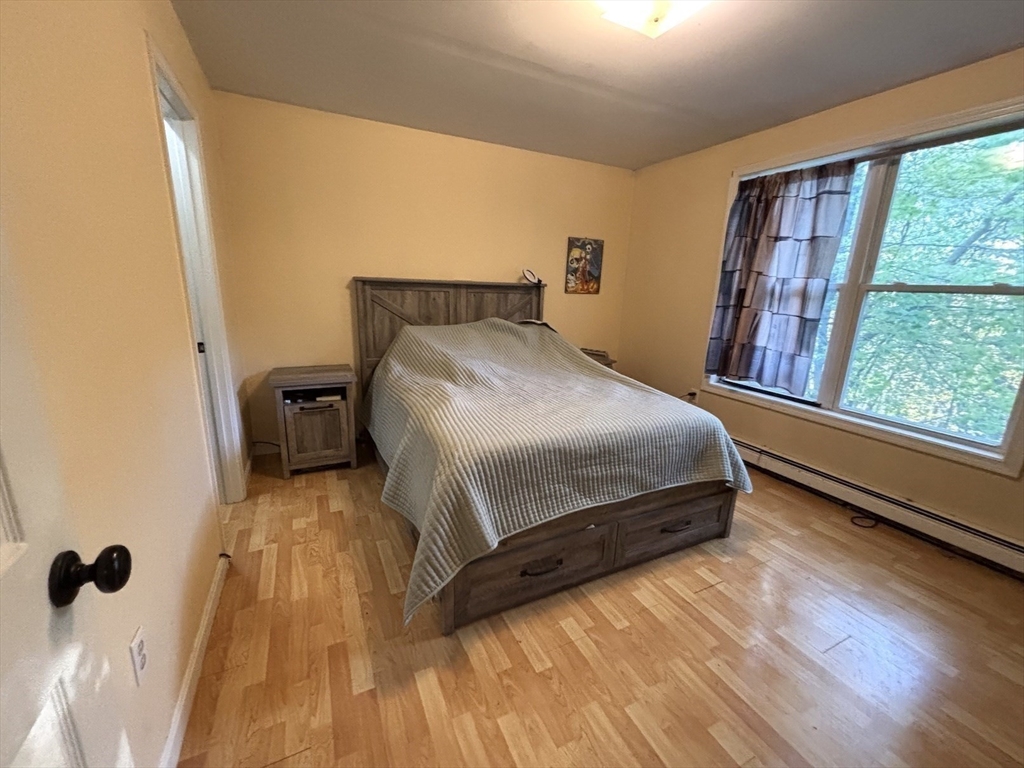 47 Grove Street Spencer, MA 01562 - Photo 11 of 27 a bedroom with a bed and wooden floor