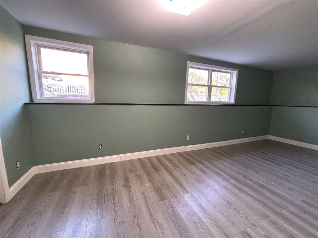 47 Grove Street Spencer, MA 01562 - Photo 13 of 27 an empty room with wooden floor and windows