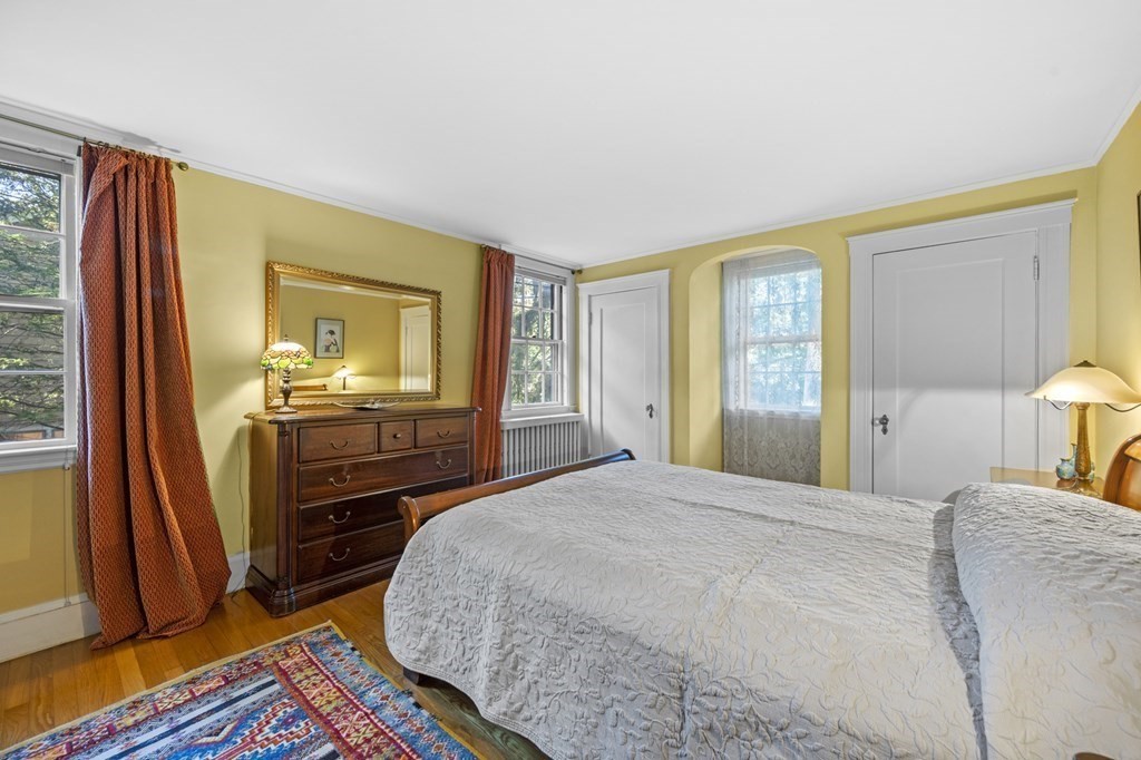 154 Mill Street Newton, MA 02459 - Photo 7 of 15 a bedroom with a bed and wooden floor