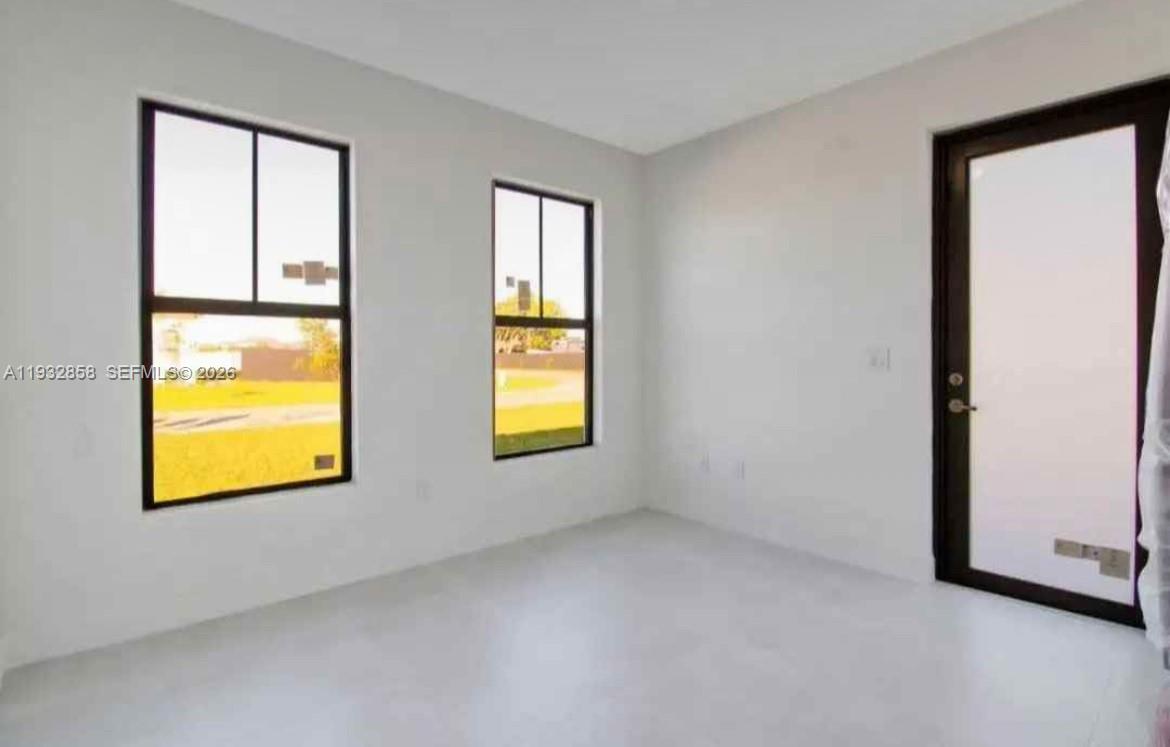 32207 Southwest 196th Avenue, Unit 2 Homestead, FL 33030 - Photo 2 of 8 a view of an empty room with a window