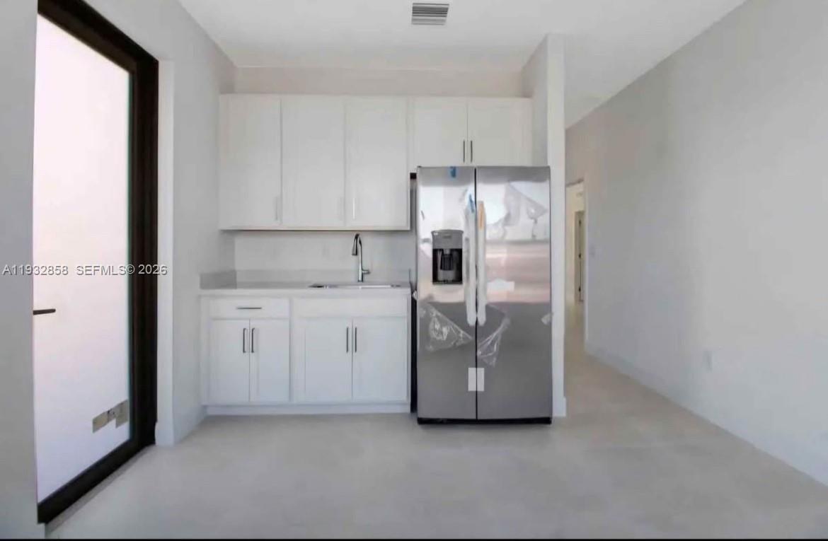 32207 Southwest 196th Avenue, Unit 2 Homestead, FL 33030 - Photo 3 of 8 a utility room with cabinets washer and dryer
