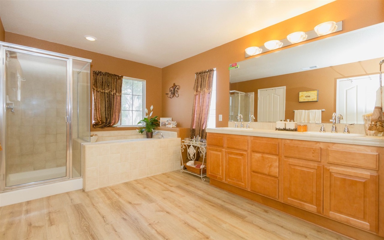 4309 Silver Spring Way Oceanside, CA 92057 - Photo 22 of 25 Featuring Brand New Desirable Flooring, with His and Hers Sinks, and Large Tub with Jacuzzi Jets.