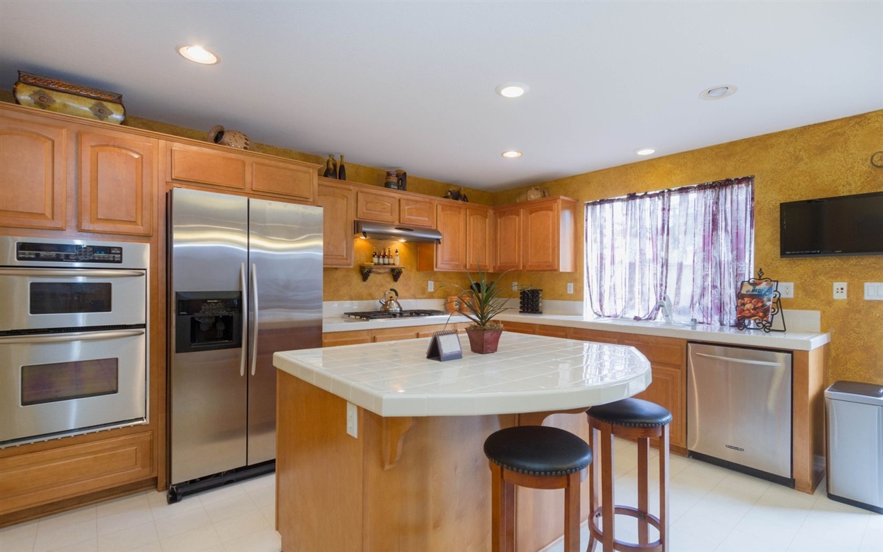 4309 Silver Spring Way Oceanside, CA 92057 - Photo 10 of 25 Large Kitchen Island with Stainless Steel Appliances.