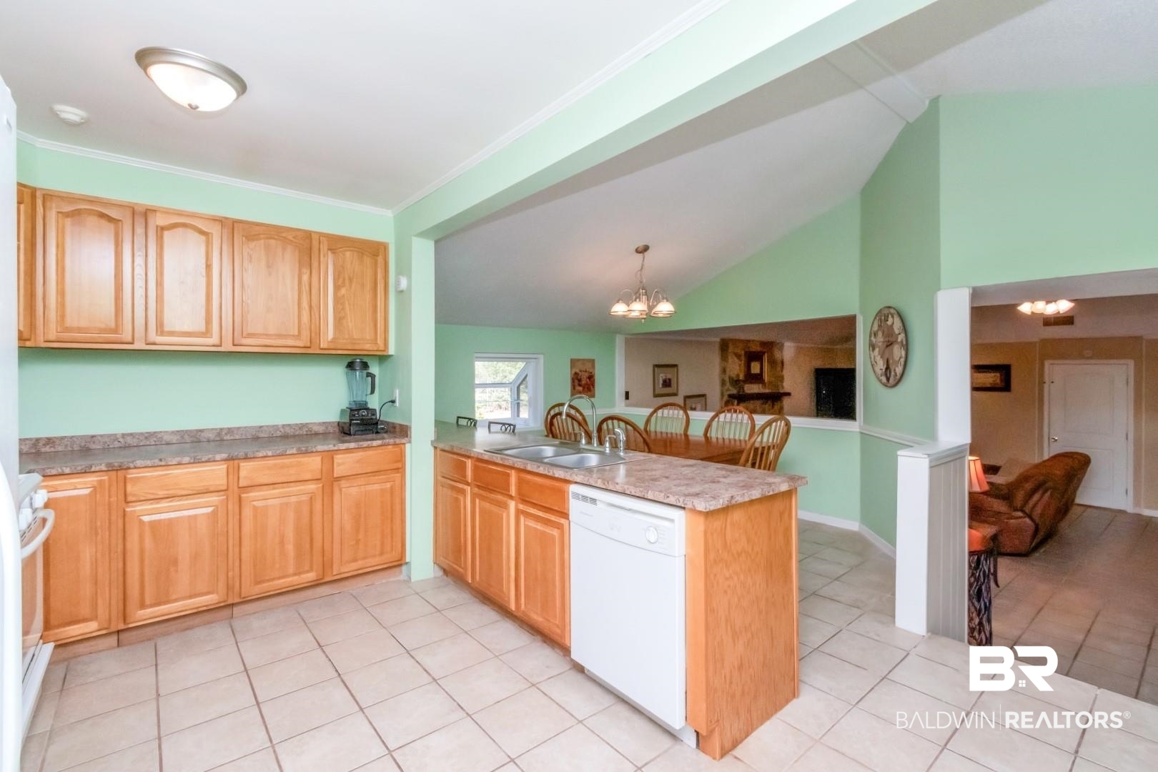 1321 Rainbow Drive West Mobile, AL 36693 - Photo 10 of 48 Kitchen with kitchen peninsula, hanging light fixtures, white dishwasher, sink, and a notable chandelier