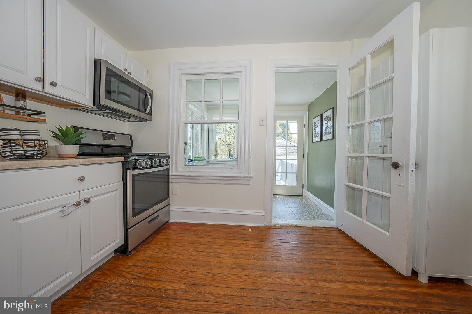 275 Old Eagle School Road Wayne, PA 19087 - Photo 18 of 47 a kitchen with granite countertop a refrigerator and a stove top oven