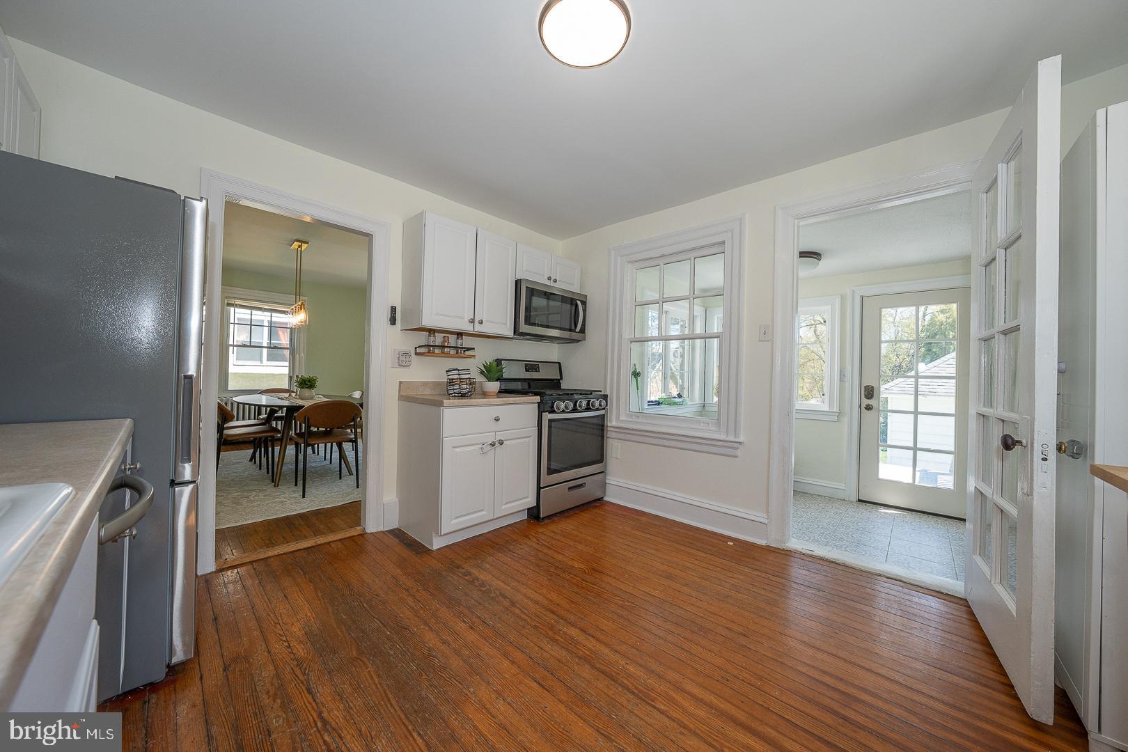 275 Old Eagle School Road Wayne, PA 19087 - Photo 21 of 47 a kitchen with wooden floors and white cabinets