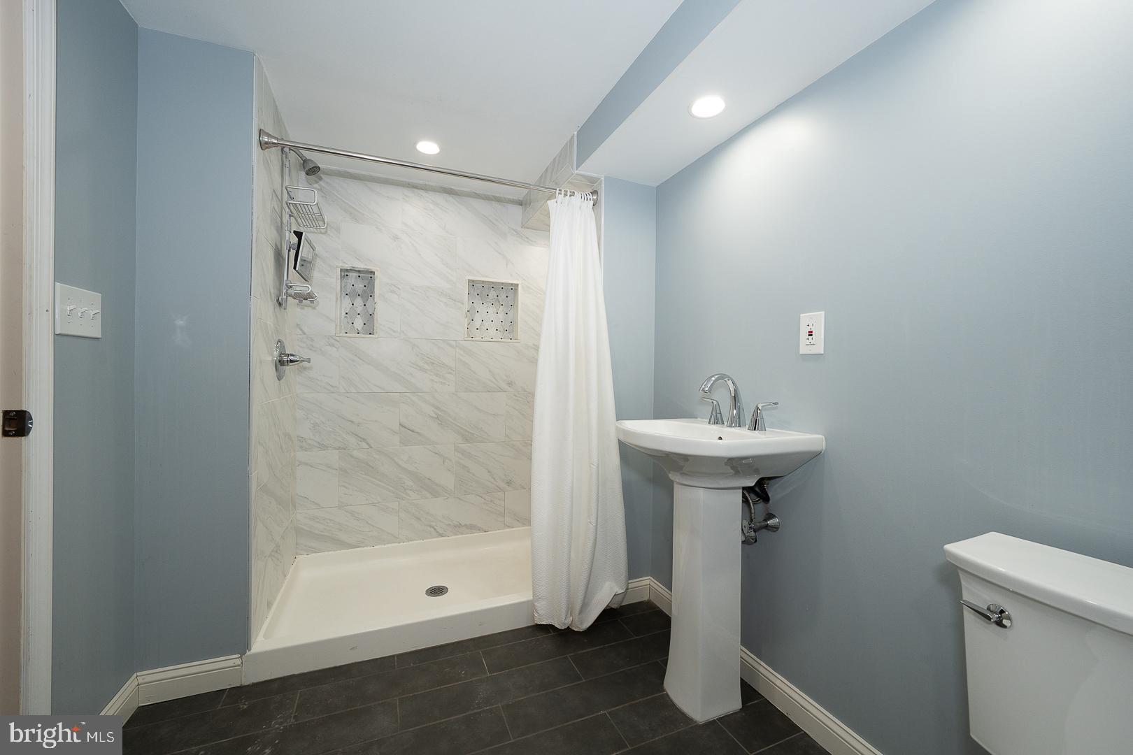 275 Old Eagle School Road Wayne, PA 19087 - Photo 27 of 47 a bathroom with a sink a toilet and shower