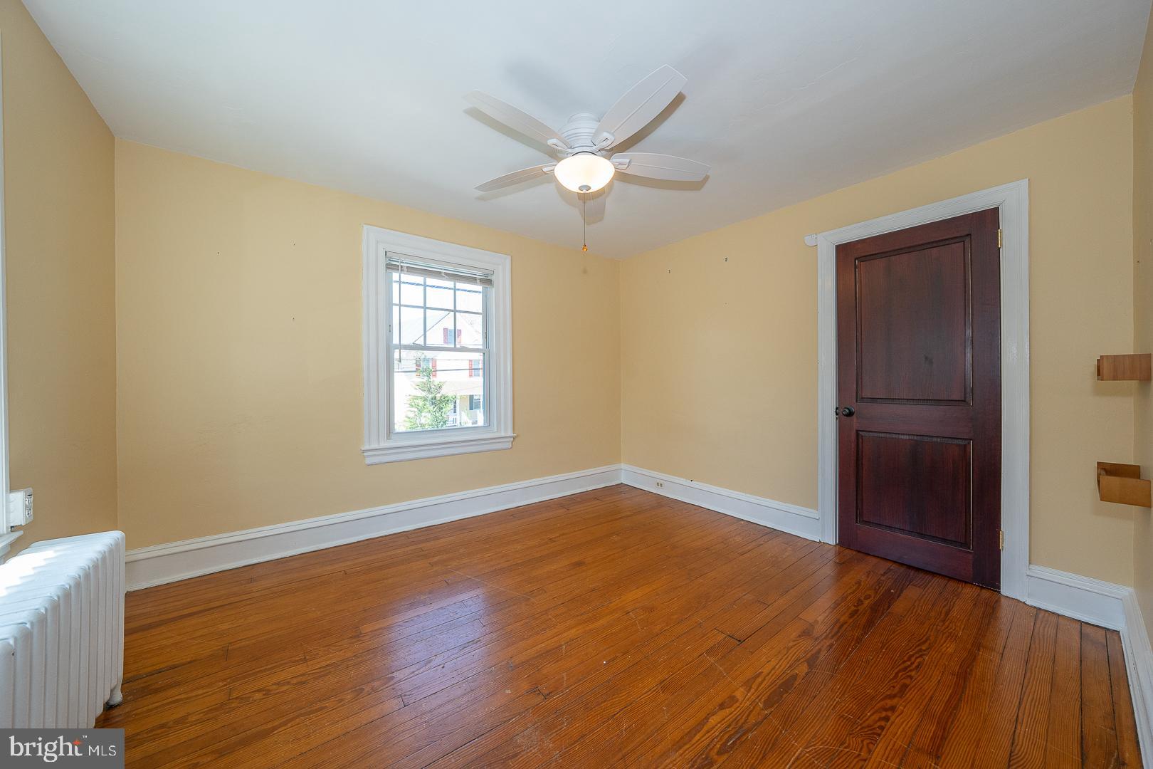 275 Old Eagle School Road Wayne, PA 19087 - Photo 30 of 47 a view of an empty room with wooden floor and a window