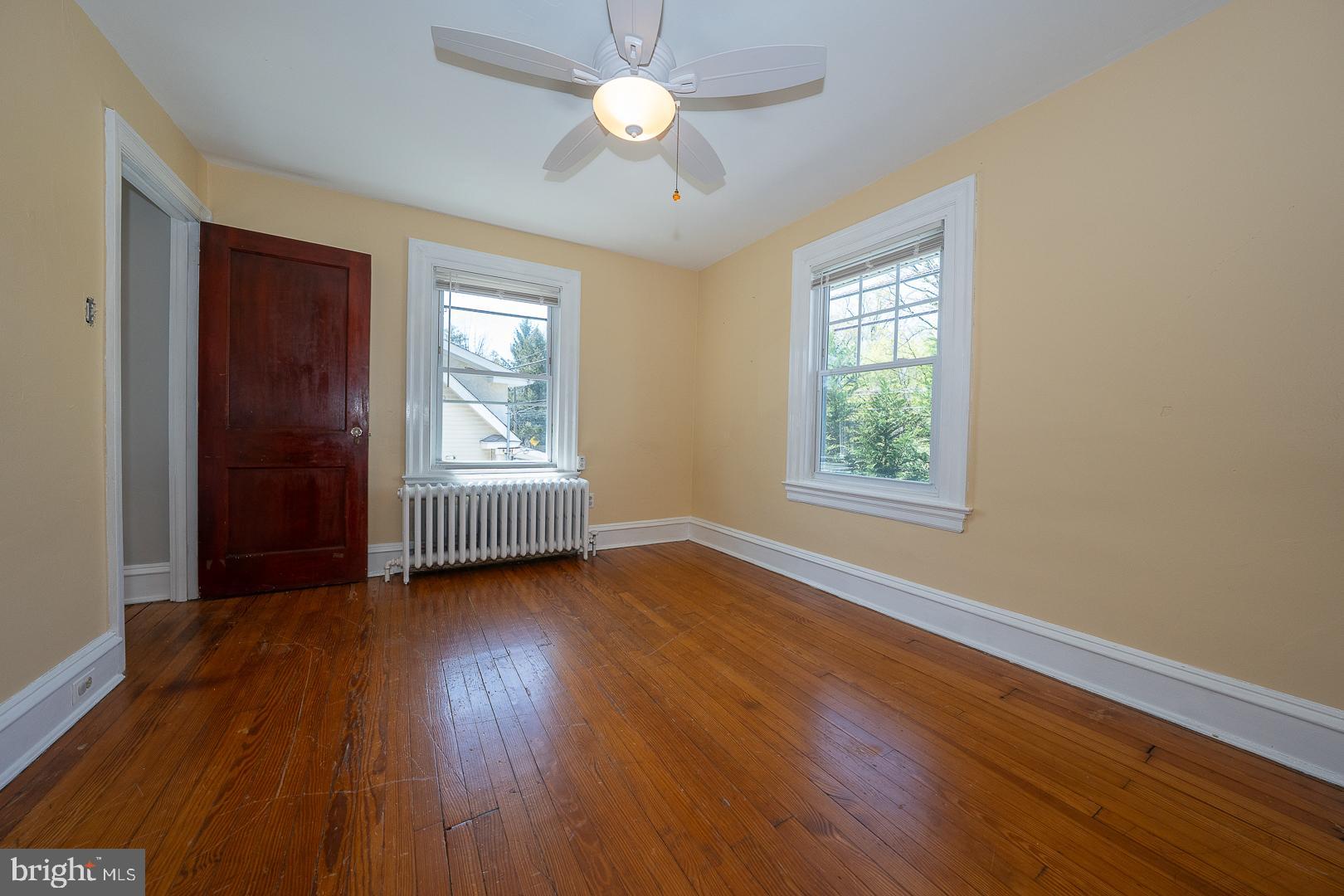 275 Old Eagle School Road Wayne, PA 19087 - Photo 31 of 47 a view of an empty room with wooden floor and a window