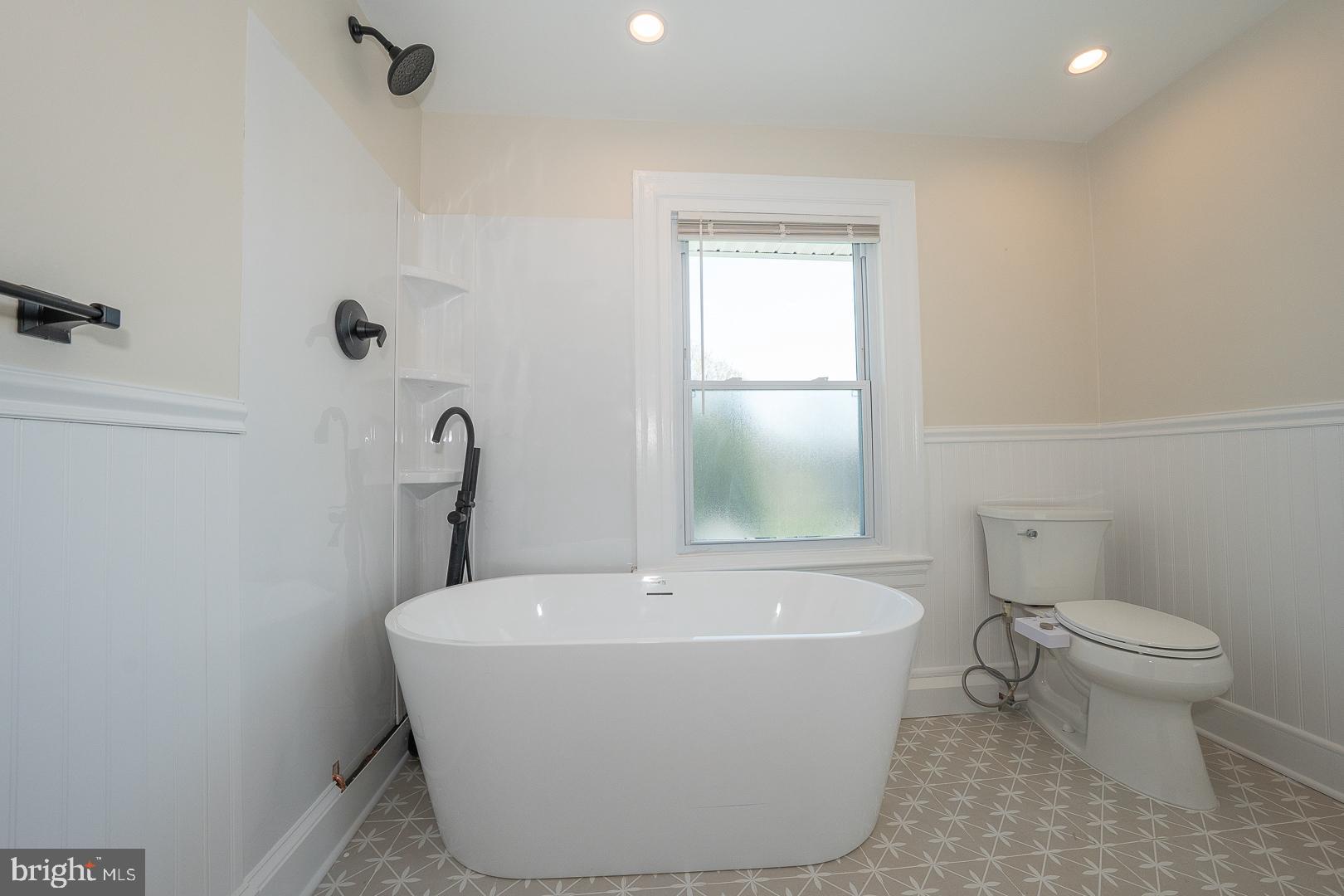 275 Old Eagle School Road Wayne, PA 19087 - Photo 34 of 47 a white bath tub sitting next to a white toilet