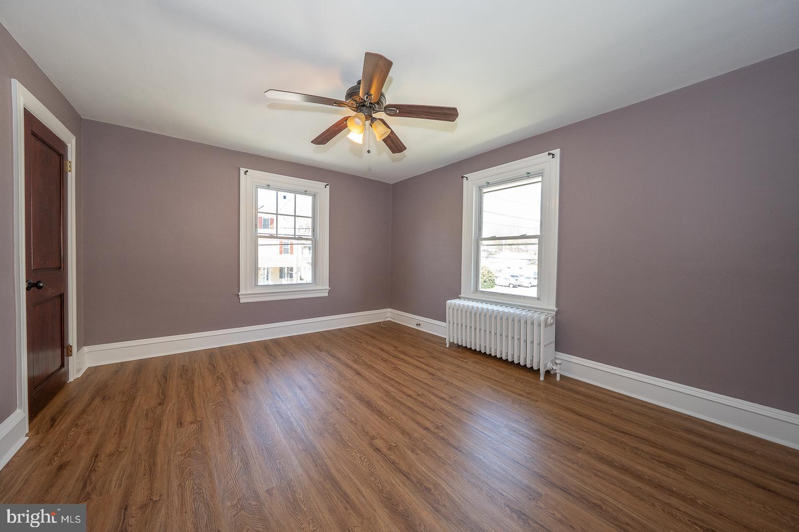 275 Old Eagle School Road Wayne, PA 19087 - Photo 37 of 47 an empty room with wooden floor windows and fan