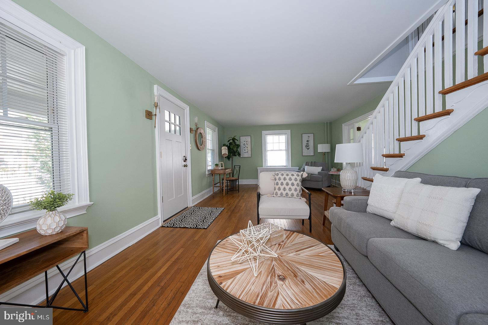 275 Old Eagle School Road Wayne, PA 19087 - Photo 8 of 47 a living room with furniture a wooden floor and a large window