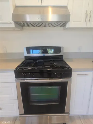 a stove top oven sitting inside of a kitchen