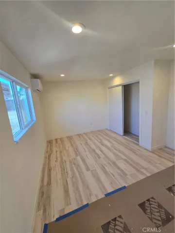 a view of a room with wooden floor and staircase