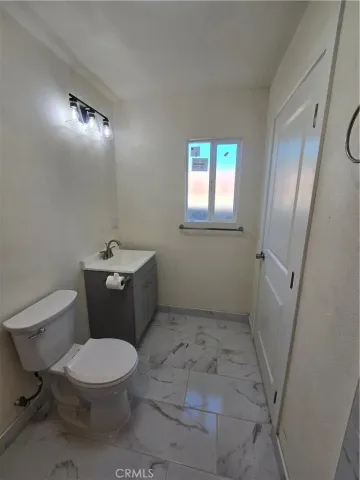 a white toilet sitting next to a bathroom sink