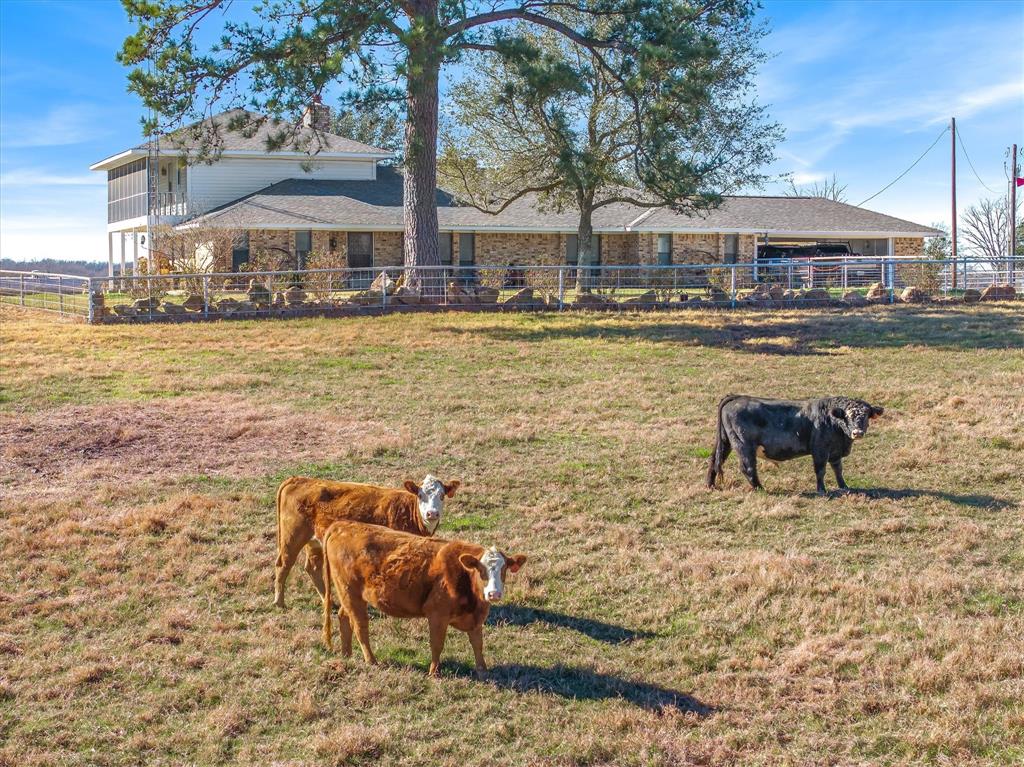 a swimming pool with outdoor seating and yard
