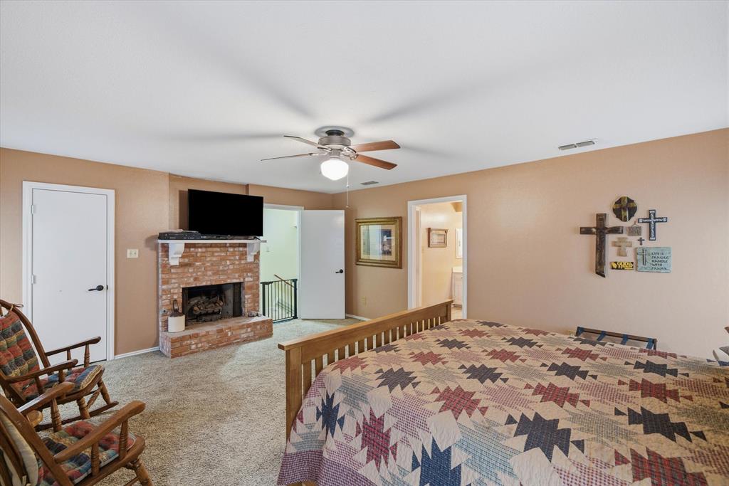 1700 Fm 1995 Van, TX 75790 - Photo 35 of 40 a bedroom with a bed and a fireplace