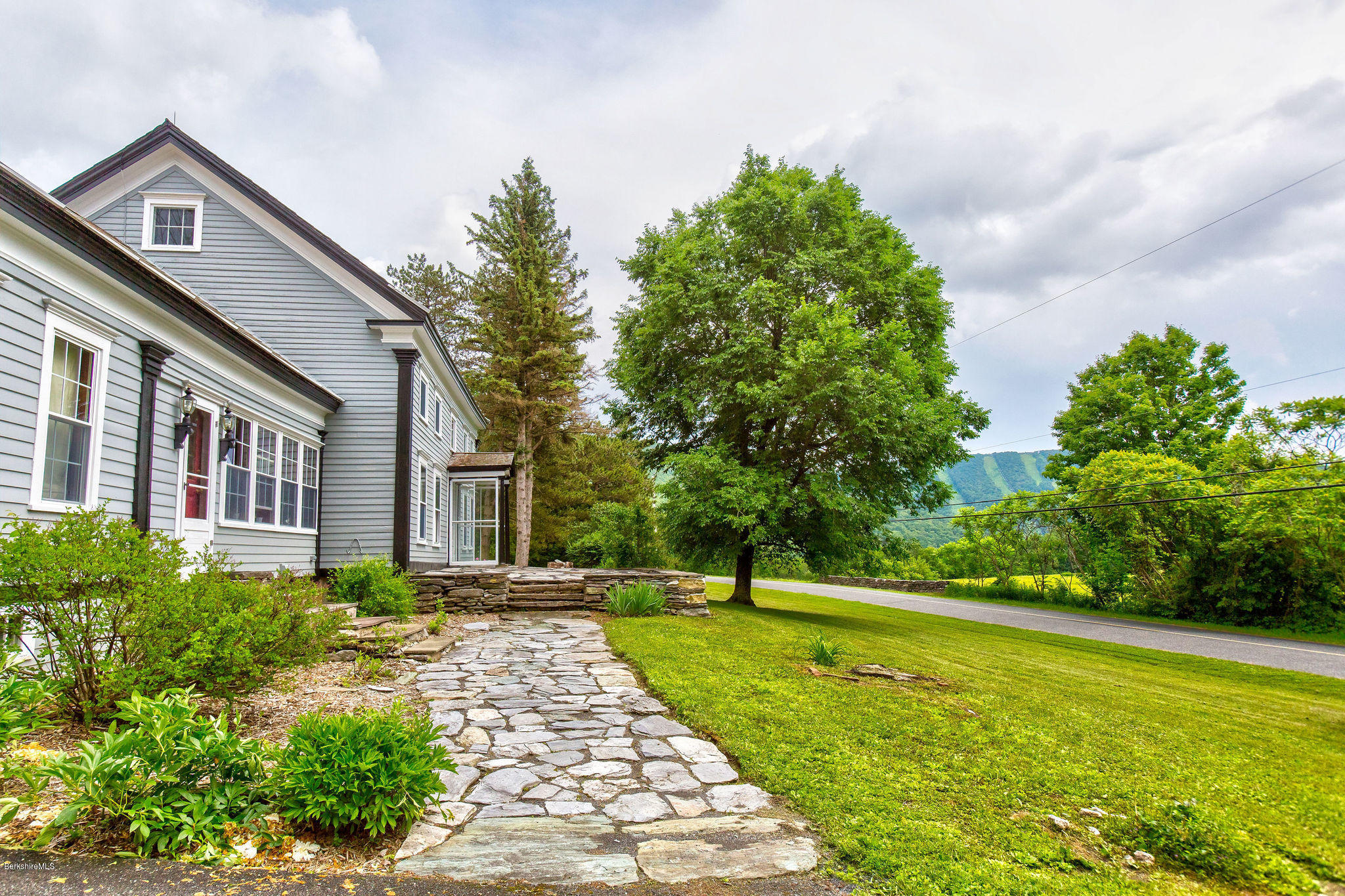246 Whitman Road Hancock, MA 01267 - Photo 1 of 38 a front view of a house with garden
