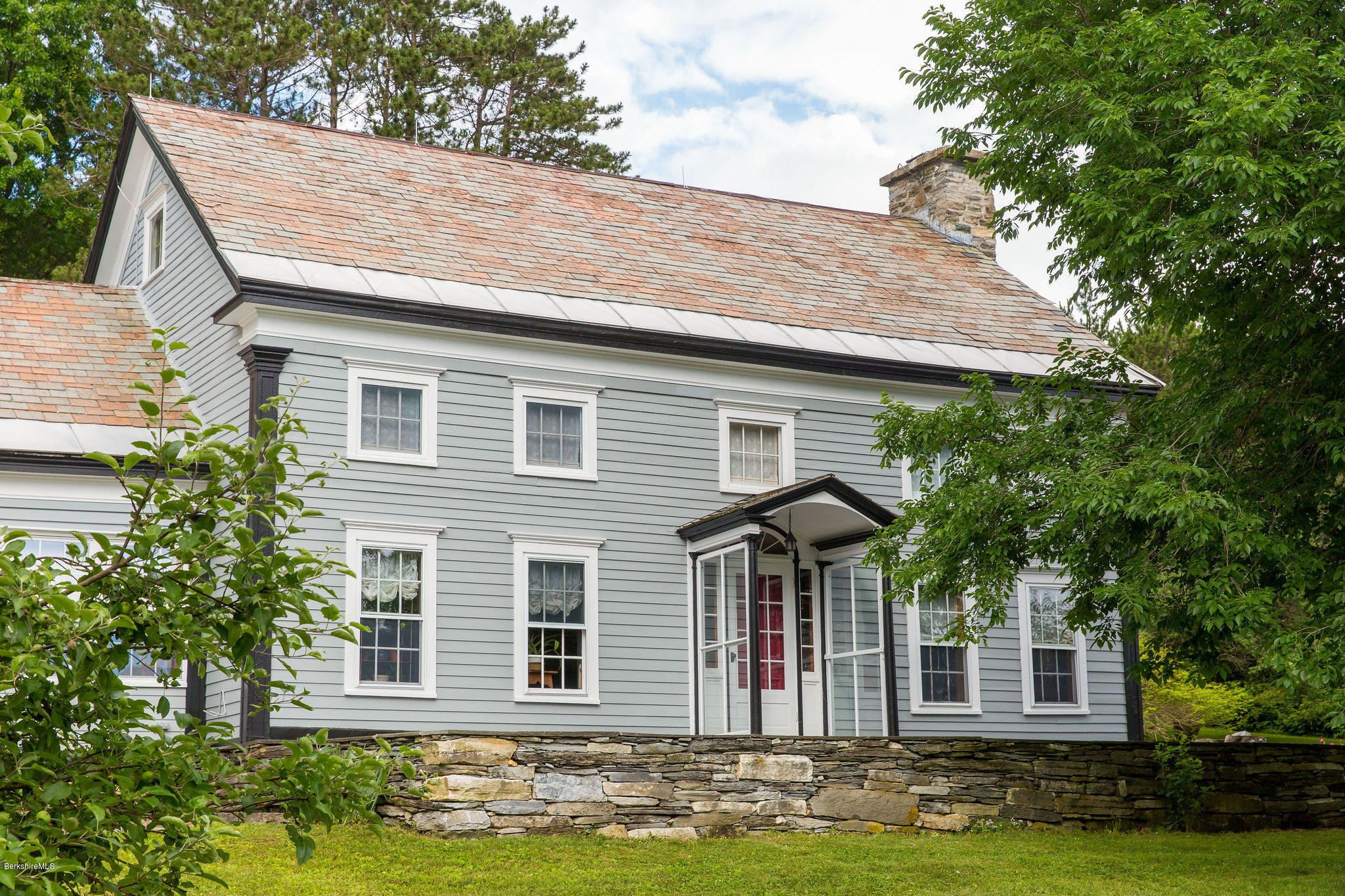 246 Whitman Road Hancock, MA 01267 - Photo 4 of 38 a front view of a house with a garden