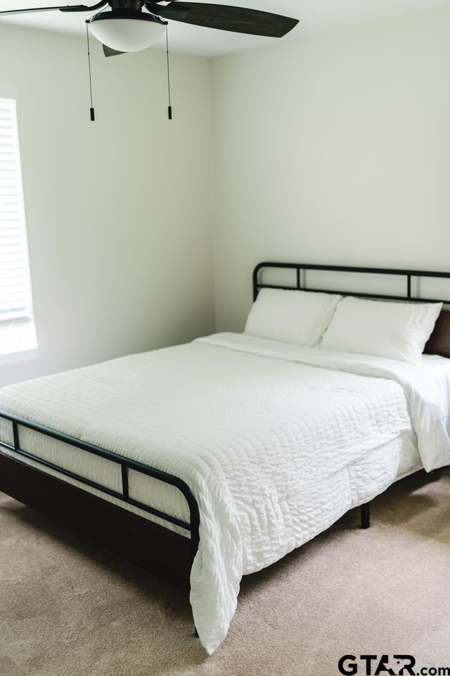 2411 Rodge Drive Tyler, TX 75701 - Photo 36 of 42 a bed sitting in a bedroom next to a window