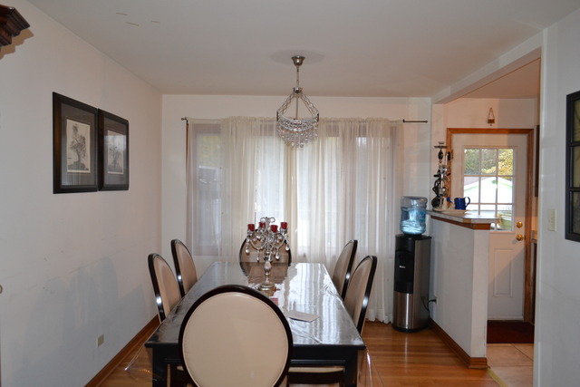 1S205 Valley Road Lombard, IL 60148 - Photo 5 of 21 a dining room with furniture a chandelier and wooden floor