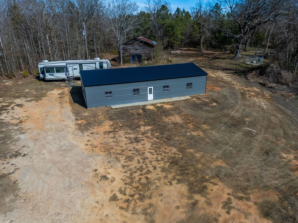 900 Asaville School Road Anderson, SC 29621 - Photo 24 of 29 This property features a sturdy metal building with a dark roof and multiple windows.