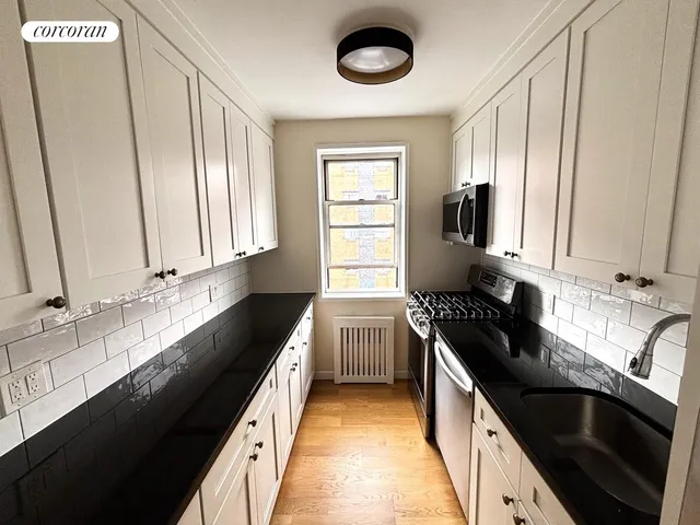 a kitchen with stainless steel appliances granite countertop a refrigerator and a stove