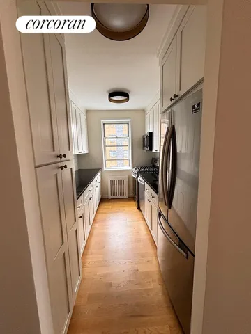 a kitchen with granite countertop a sink stove and cabinets