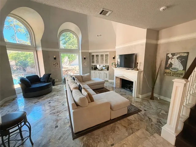 a living room with furniture a fireplace and a flat screen tv