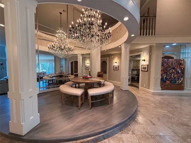 a living room with furniture and a chandelier
