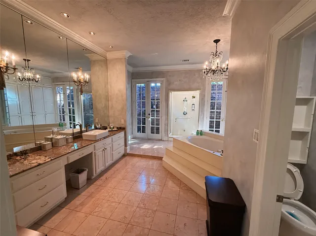 a large bathroom with a large tub and sink