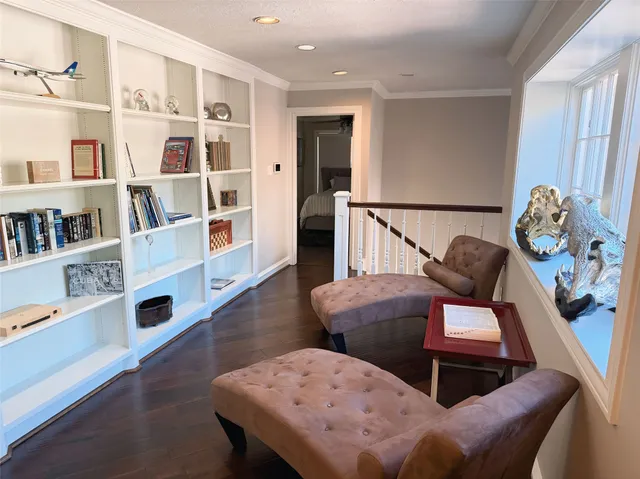 a living room with furniture and a book shelf