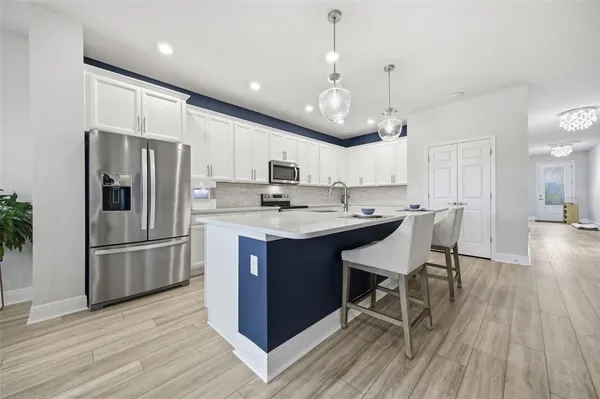 a stove top oven sitting inside of a kitchen