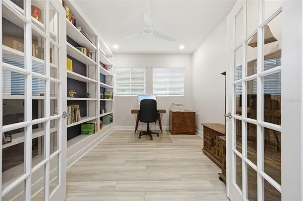 a bedroom with a bed and a flat tv screen on dresser
