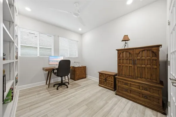 a bedroom with furniture and a wooden floor