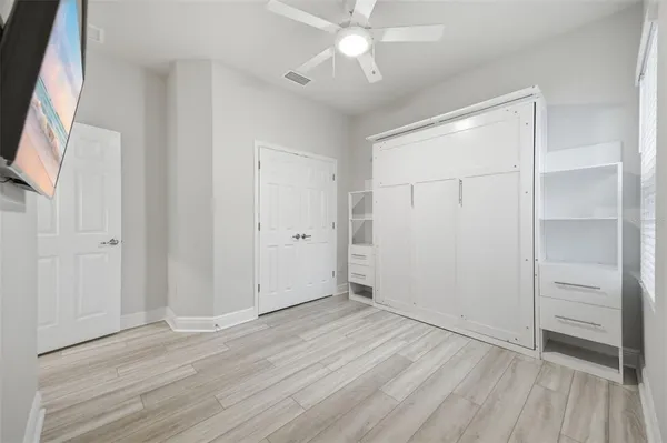 a bedroom with a large bed and a large window