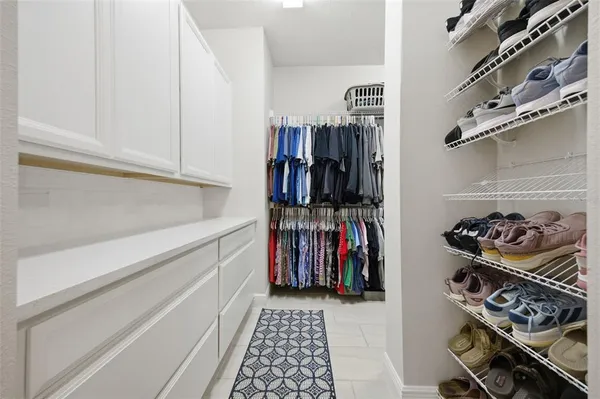 a spacious bathroom with a shower sink and mirror