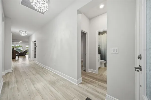 a living room with furniture potted plant and a table