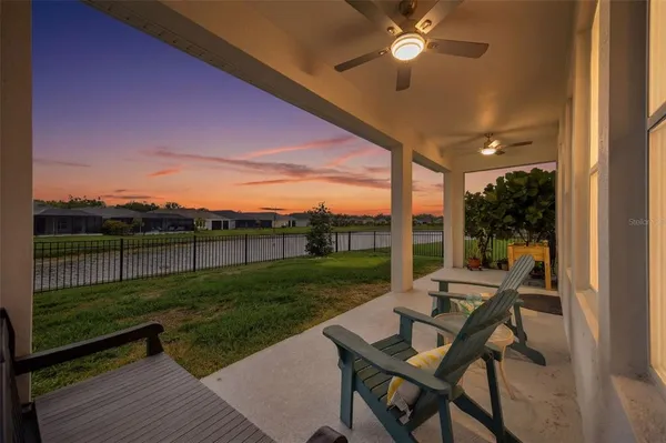 an aerial view of a house with outdoor space and lake view