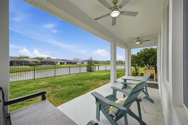 a swimming pool with outdoor seating and yard