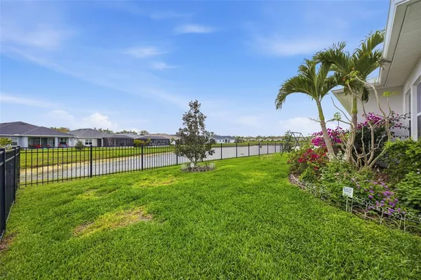 a room with pool table a large window and furniture