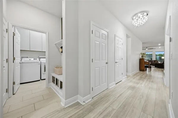 a living room with furniture kitchen view and a potted plant