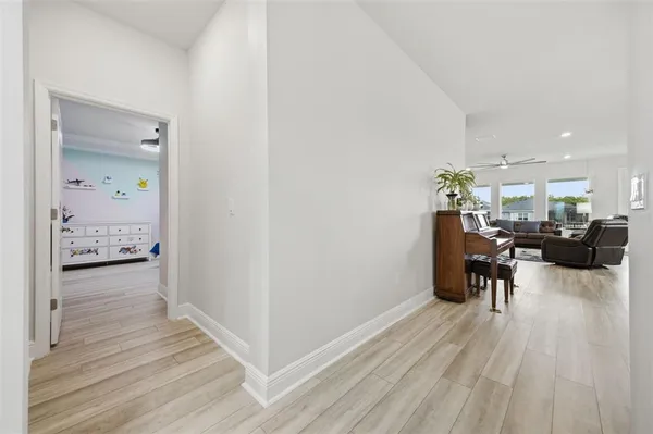 a kitchen with stainless steel appliances kitchen island granite countertop a table chairs and a refrigerator