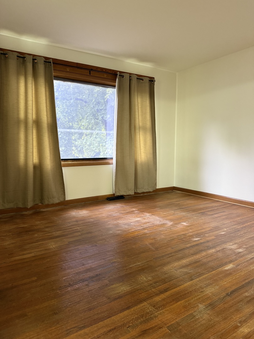 405 North Church Street Princeton, IL 61356 - Photo 11 of 24 a view of an empty room with wooden floor and a window