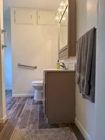 a bathroom with a sink toilet and shower